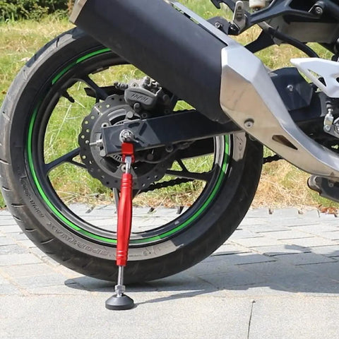 Motorcycle Front And Rear Wheel Stand Lift Portable Trail Stand For Easy Safe Wheel Lifts Doubles As Rear Or Front Lift Sixth Generation Red Compact 29cm Travel Size For Dirt Bikes And Street Bikes supporting rear wheel on pavement