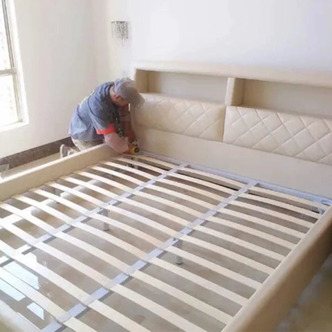 Man installing Heavy Duty Bed Rail Hooks And Universal Frame Connector Plates For Wooden Beds in a bed frame.