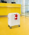 Mint Blue And Pearl White 18 Inch Carry On Suitcase With A Built In USB Charging Port And Roomy Power Bank Pocket standing in airport.