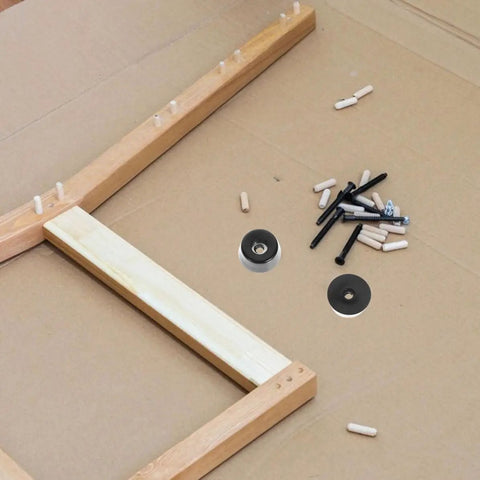 30 Pack Non Slip Rubber Feet Replacement Pads for Cutting Boards and Tables next to table assembly items on cardboard.