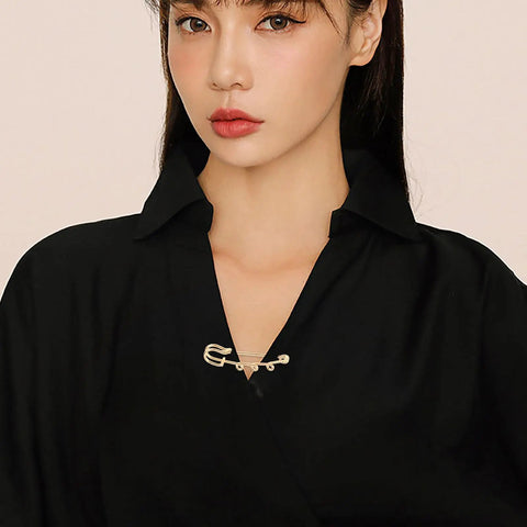 Premium 20 Pack Of Versatile Loop Safety Pin Brooches To Clasp Sweaters Scarves And Denim Belts While Adding Instant Chic Vibes To Everyday Streetwear And Casual Fits, modeled on a black shirt.