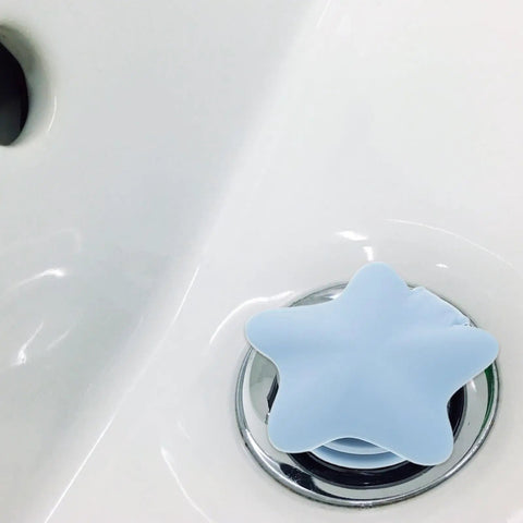 2pcs Star Shaped Silicone Tub Drain Plug for Bathtub Sinks, Fixed in light blue placed in a white sink.