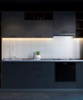 Dark kitchen with 2-Pack Rechargeable LED Strip Lights With Motion Sensor 2M Cool White under cabinet lighting, illuminating workspace.