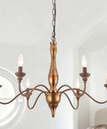 Six Light Distressed White French Country Candle Chandelier With Cozy Vintage Vibe, 24 Inch Wide Rustic Ceiling Fixture in living room.
