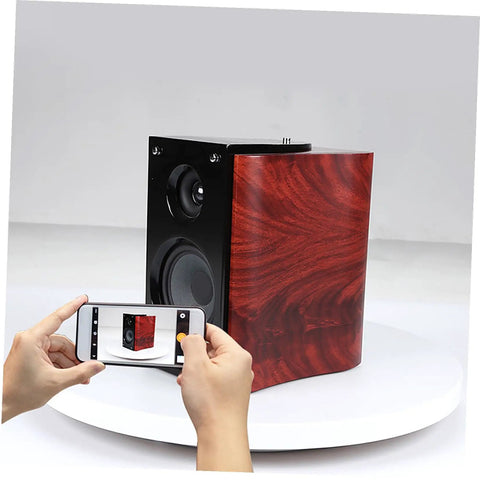 Sparkling 360 Rotating Turntable Display Stand For Jewelry Watches And Digital Products Mirror Base Electric Spin Platform showcasing a wooden speaker.