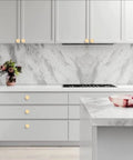 10 Pack Brushed Gold Round Cabinet Knobs For Kitchen Cabinets And Dressers, 1.2 Inch Diameter, Zinc Alloy Hardware installed on white cabinets