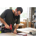 Pro Grade Pneumatic Pin Nailer For Cabinet Trim And Fine Woodworking ships ready, used by a man in a workshop.