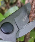Pro Grade 8 Inch Bypass Pruning Shears With Japanese SK5 Steel Blades cutting a branch, emphasizing the precision and control.