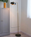 Felipe Floor Lamp With Tilting Head, Antique Brass Finish And Matte Black Accent, Mid Century Modern Style