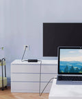 Global AC DC Power Adapter For Elecraft PX3 Ham Radio connected near a laptop on a white dresser, powering the device safely.