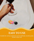 Mermaid Bathtub Stopper Plug Rubber Drain Seal with Chain in a bathtub, held above by a hand with a wine glass.