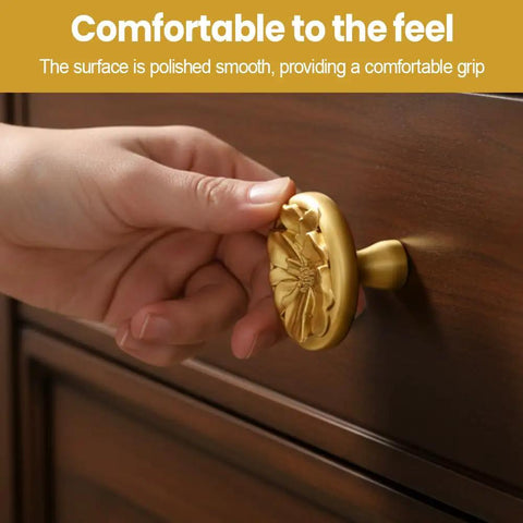 Hand holding Two Pack Zinc Alloy Cabinet Knobs With Floral 3D Design For Dressers Wardrobes And Cupboards on wooden drawer