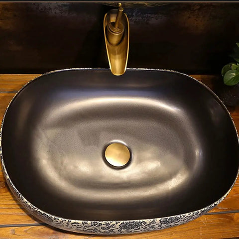 USZWBY Vessel Sinks Bathroom Vessel Sink Creative Ceramic Washbasin Retro Art with sleek black finish and gold faucet.