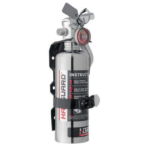 Heavy Duty Compact Fire Extinguisher For Cars Trucks Race Rigs Clean Halotron Formula Beats Dry Powder No Fuss Safe For Engines And Electronics Ul Listed Chrome Body One Point Four Pound mounted on bracket with safety instructions.