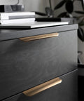 Five Pack Adhesive Edge Pulls For Cabinets No Drill Hidden Drawer Handles Flat Stick On Brushed Gold Finish installed on black cabinet