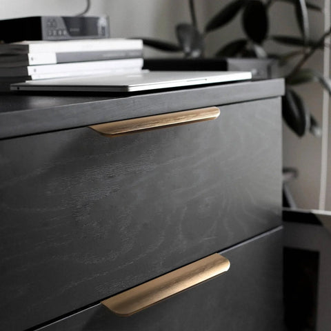 Five Pack Adhesive Edge Pulls For Cabinets No Drill Hidden Drawer Handles Flat Stick On Brushed Gold Finish installed on black cabinet