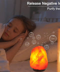 Himalayan Salt Lamp With 8 Color Changing Glow For A Cozy Lit Vibe 100 Percent Natural Crystal Salt Light beside sleeping person