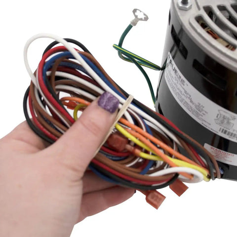 Person holding wiring for HVAC Blower Motor Replacement Three Quarters HP 1 Phase Three Speed 120 Volt 1075 RPM Model Specific