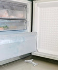 Open freezer with 10 Pack Aluminum Freezer Shelf Clips With Polished Surface For Easy Fridge Organization on floor