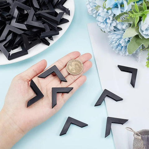 Kick Those Dull Scratches Straight To The Trash With These Heavy Duty Black Plastic Corner Protectors And L Shaped Bumpers Made To Keep Your Frames Mirrors And Glass Secure, shown with a coin for size reference.