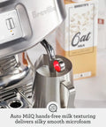 Automatic Espresso And Cold Brew Coffee Maker Featuring Touch Display Auto Milk Frothing Wand For Silky Microfoam in action with milk pitcher.