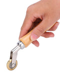 Steel seam roller with wooden handle and brass wheel for wallpapering or roofing membrane work.