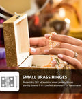 Person holding pearl necklace over open jewelry box with small brass hinges visible, perfect for DIY jewelry boxes.