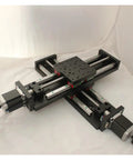 Top Shelf Precision Motorized Rotary Positioning Stage Featuring Slick Electric Linear Slide And Smooth Riding Worm Gear Drive For Heavy Duty Optics Setup Includes NT102TA500M Cross Module Rail System, viewed from above.