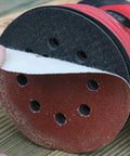 Super Tough 40 Piece 5 Inch Ultra Fine Aluminum Oxide Sanding Discs With Eight Hole Hook Loop Backing For Random Orbital Sanders and Auto Detailing Jobs In Assorted Grits 60 To 240 For Smooth Woodwork and Finish Work attached to a sander.