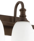 Detail of oiled bronze finish fixture on Three Light Bathroom Vanity Light In Oiled Bronze With Clear Seeded Glass From The Richmond Collection