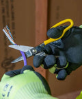 Cable Splicer Kit With Electricians Knife And Free Fall Snip Includes Leather Tool Holder For Belts Up To Two Inches The Essential Gear For Cable And Phone Techs On The Job showing gloved hands using snip on purple cable.