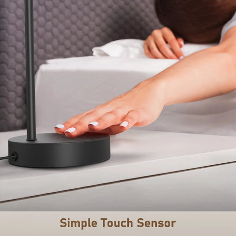 User tapping base of Industrial Table Lamp Set Of 2 With Dual USB Charging Ports, 3-Way Dimmable Touch Control Bedside Lamps, on nightstand.