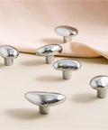 Mid Century Pebble Brass Cabinet Handles And Irregular Knobs Set in chrome finish on display surface