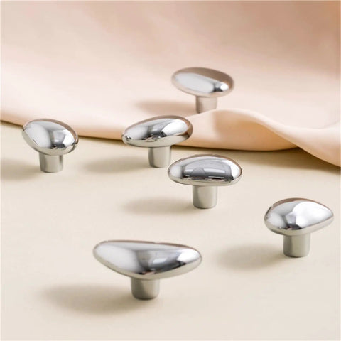 Mid Century Pebble Brass Cabinet Handles And Irregular Knobs Set in chrome finish on display surface