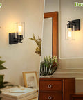 Modern Wall Sconces Set Of Two For Bathroom Vanity Killer Matte Black Finish With Clear Glass Shades in up and down positions.