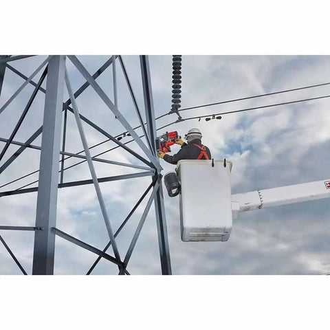 Portable Lineman Magnetic Drill Kit being used for power drilling on a tall structure by a worker in a bucket truck.