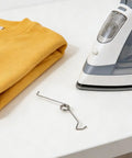 10pcs Super Durable Torsion Springs For Steam Iron Repair Kit Made Of Premium Stainless Steel That Stand Up To Heavy Use And High Heat With Universal Fit For Most Models To Get Your Device Back Up And Running Smooth As Silk, stainless steel spring beside steam iron and folded shirt