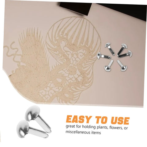 100 Piece Iron Brads With Double Leg Pins For Puppet Craft, Scrapbooking, Doll Making, shown with decorative background