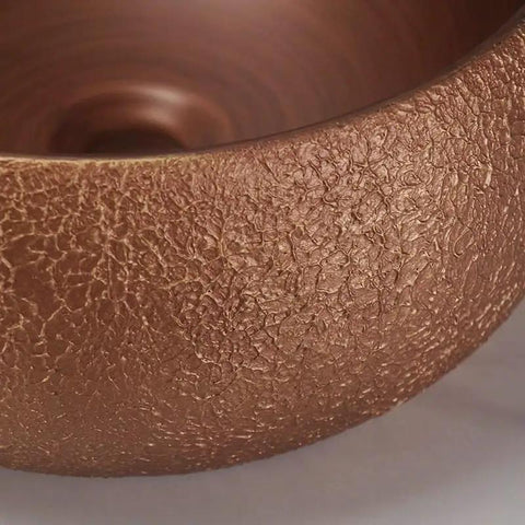 Close-up of the textured rose gold ceramic surface of USZWBY Vessel Sinks Bathroom Sink European Round Rose Gold Home Hotel Above Counter Basin.