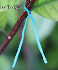 Top Shelf Flat Iron Wire Twist Ties For Garden Vine Support And Plant Securing Reusable Red Gardening Strips With Sturdy Metal Core shown securing a plant branch.