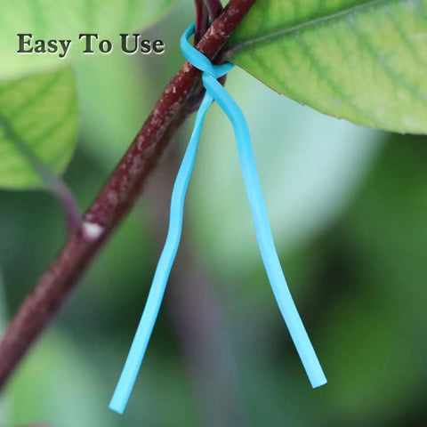 Top Shelf Flat Iron Wire Twist Ties For Garden Vine Support And Plant Securing Reusable Red Gardening Strips With Sturdy Metal Core shown securing a plant branch.