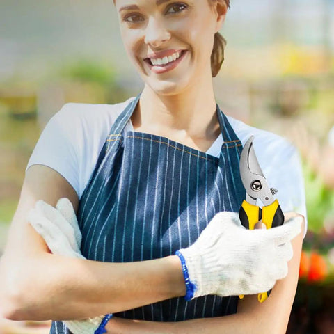 Person holding yellow Three Pack Garden Pruning Shears With Stainless Steel Blades Handheld Clippers in garden setting.