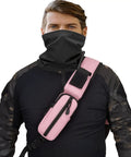 Person wearing a pink Tactical Sling Crossbody Bag With Moveable Universal Holster 15L Capacity, dressed in outdoor attire