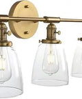 Three Light Industrial Wall Sconces In Antique Brass With Clear Glass Shades, Vintage Vanity Lighting with bell shade style