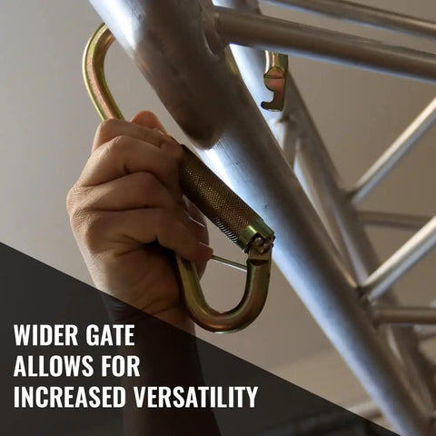 Hand using Heavy Duty Steel Locking Carabiner For Fall Protection Systems and Tower Hook Applications on metal structure