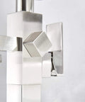 Close-up of brushed nickel floor mounted tub filler faucet control with waterfall spout and handheld sprayer connection details