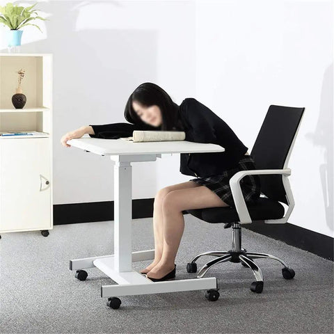 Slick Electric Height Adjustable Lectern With Smooth Roll Wheels For Boardroom Church Or Lecture Hall Speaking Ergonomic Mobile Standing Podium Designed For All Day Grind And Zero Sweat Operation with a user resting on a desk.