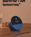 Dope Wireless Smart Alarm Clock With Sleek Build And Thumping Bass Solid For Nightstands Or Kitchens Checks Weather Streams Tracks Manages Connected Devices Glossy Black on a wooden table.