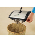 Lightweight Manual Carpet And Hard Floor Sweeper Featuring Dual Rotating Brush Roll Plus Corner Edge Brushes collecting pet hair.