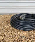 Heavy Duty 50 Amp Generator Extension Cord 100 Feet Jobsite Power Distribution Splitter Dual Feed Plug And Play on gravel surface